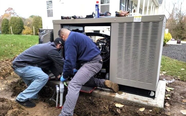 a photo of two workers maintaining a generator.